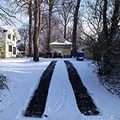 Heated asphalt tire tracks in driveway
