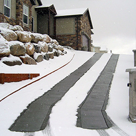 Heated driveway on incline with heated tire tracks