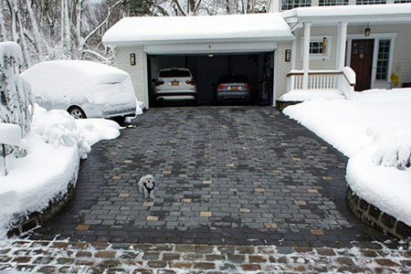 A heated paver driveway after a snowstorm