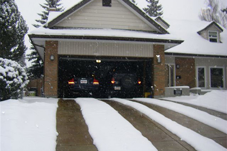 Two sets of heating tire tracks in driveway.