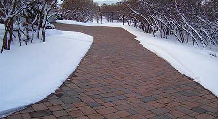 Installation of snow melting mats installed over paver sand.